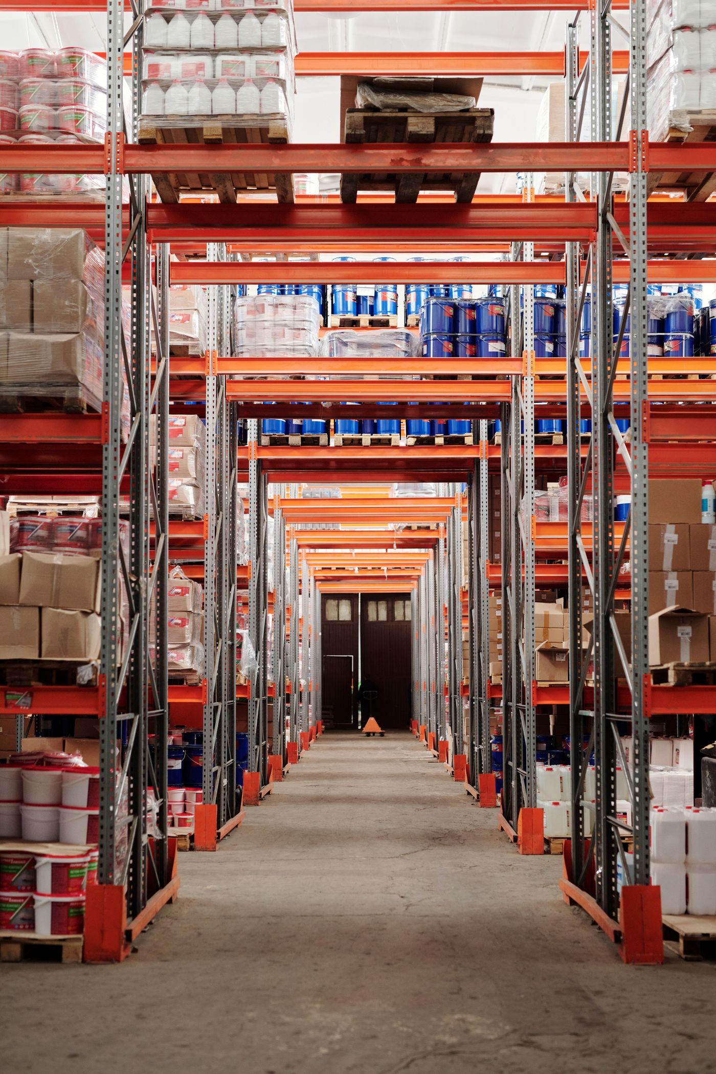 Stocked warehouse racks containing pallets, containers and boxed goods